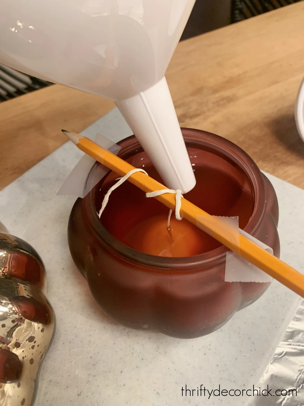 pouring wax into candle